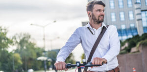 Businessman riding a scooter in the city