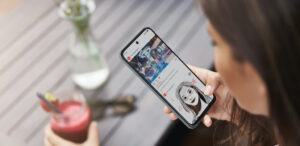 Upper angle shot young tanned woman holding smartphone sit outdoor cafe taking photo smoothie post online blog page, travel blogger writing post about new restaurant, photographing drink